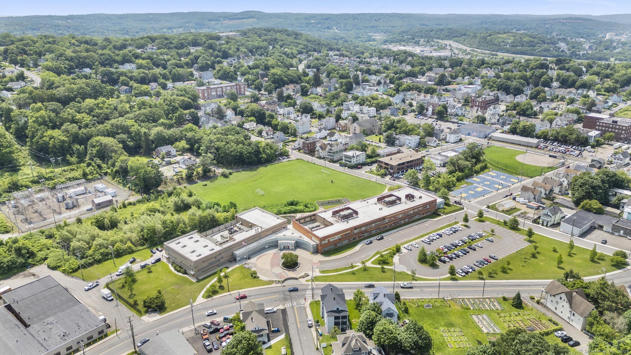 1105 North Main Street, Unit 1 Waterbury, CT 06704 - Photo 6 of 37 an aerial view of a city with lots of residential buildings
