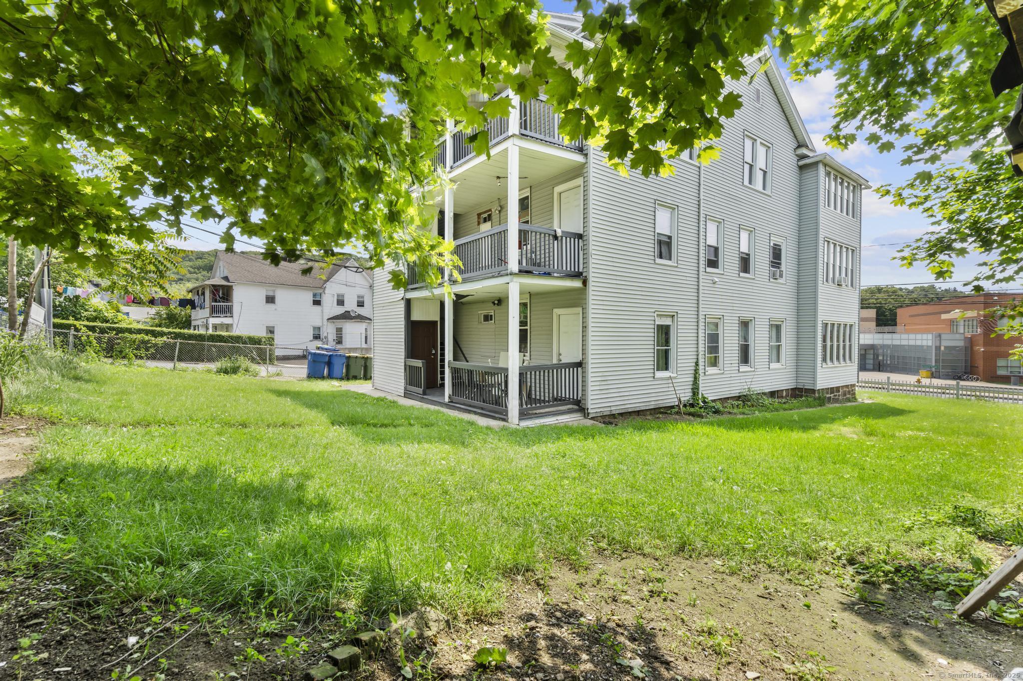 1105 North Main Street, Unit 1 Waterbury, CT 06704 - Photo 7 of 37 a view of a house with backyard and garden