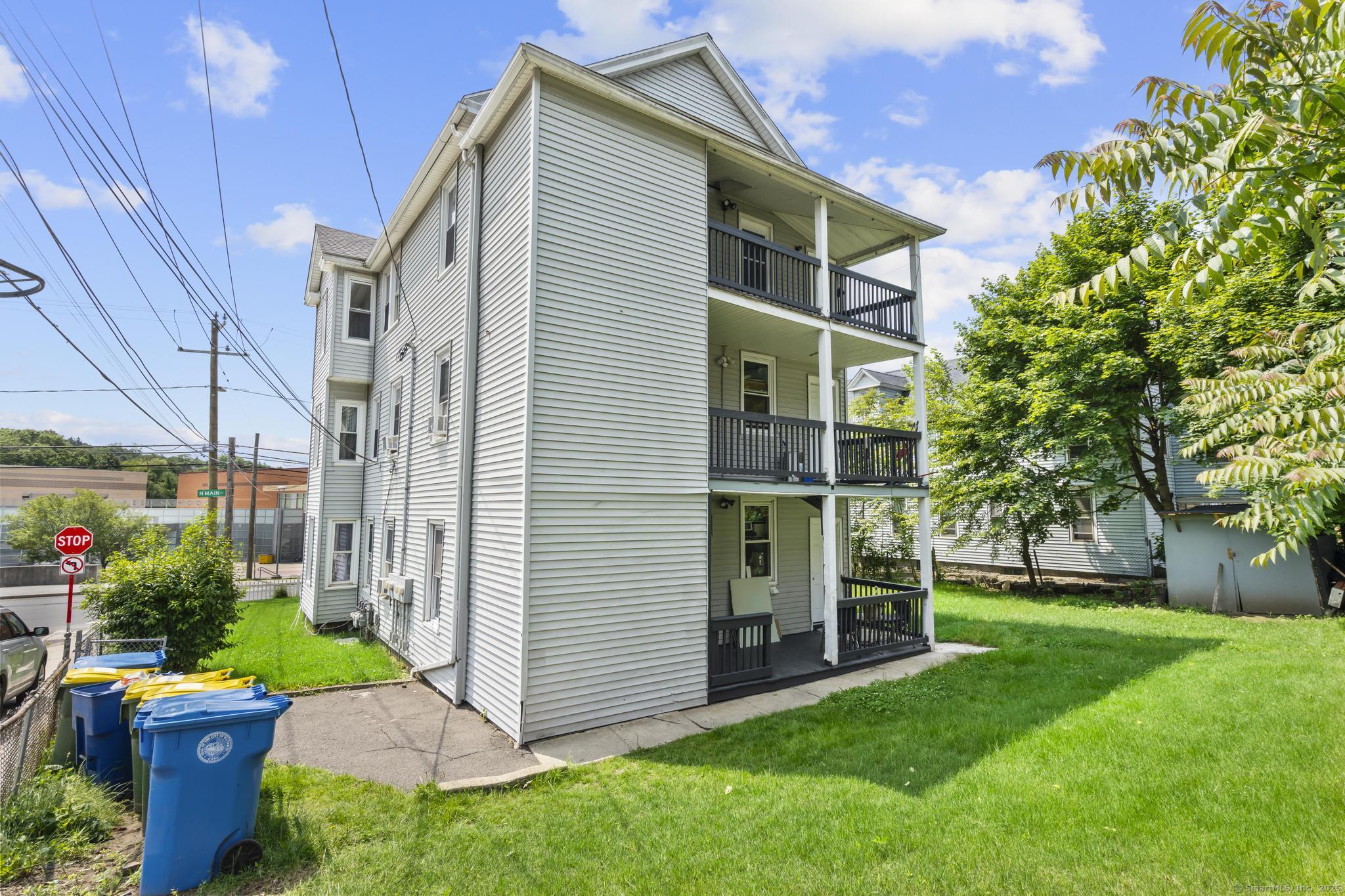 1105 North Main Street, Unit 1 Waterbury, CT 06704 - Photo 9 of 37 a view of a house with backyard and garden