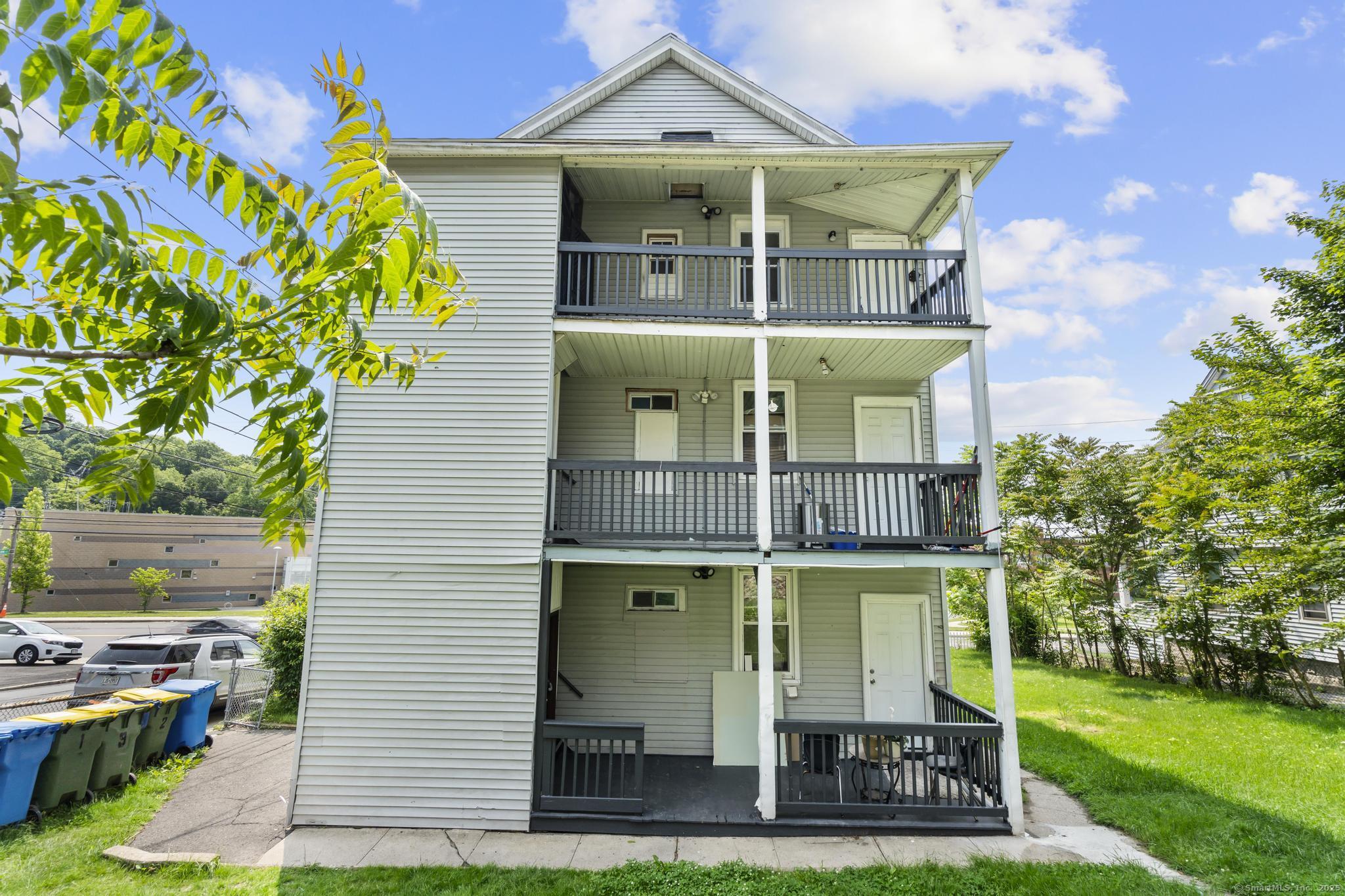 1105 North Main Street, Unit 1 Waterbury, CT 06704 - Photo 10 of 37 front view of a house with a yard