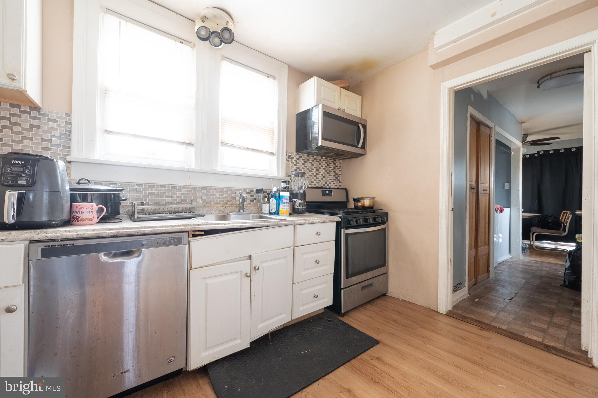 706 Augustine Road Atlantic City, NJ 08401 - Photo 13 of 29 a kitchen with white cabinets and sink