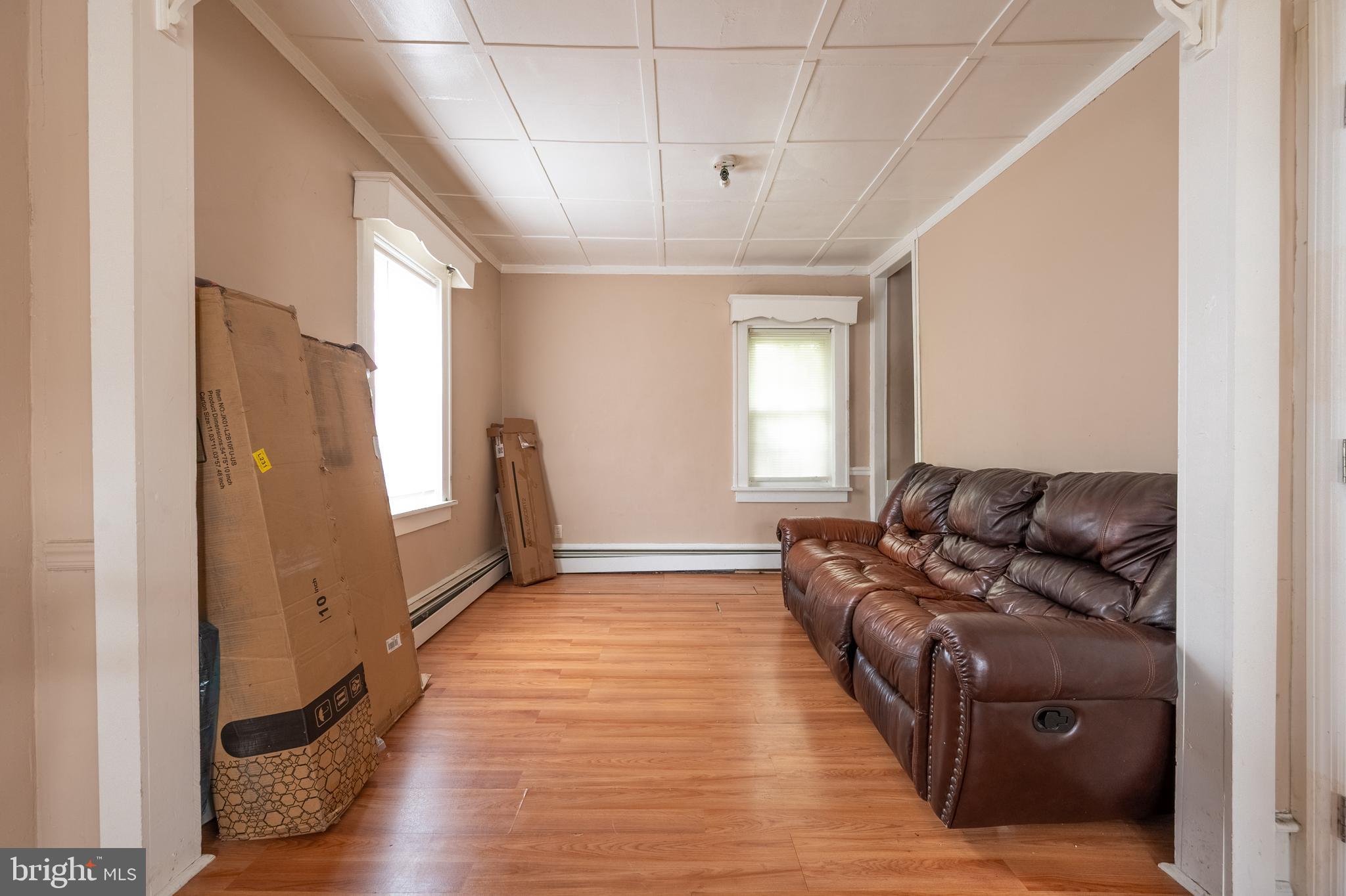 706 Augustine Road Atlantic City, NJ 08401 - Photo 10 of 29 a living room with furniture windows and a chandelier