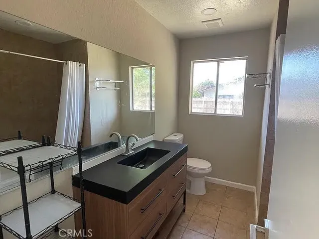 a view of a room with a chandelier fan and windows