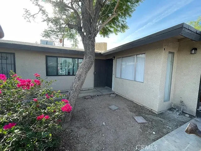 a flower garden in front of a house