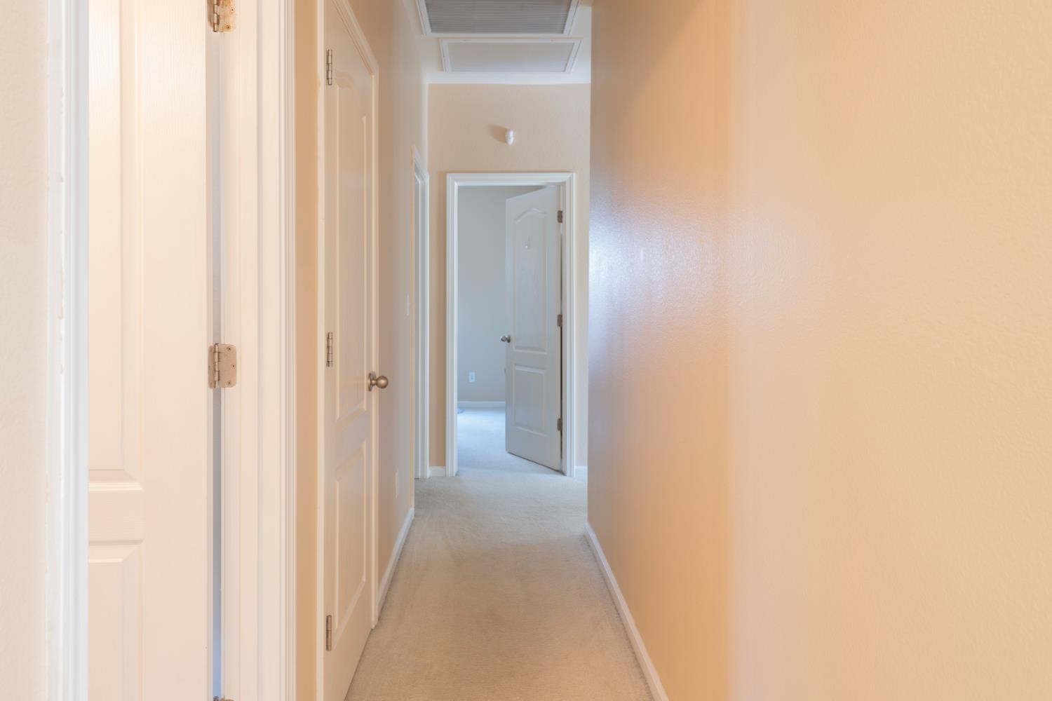 6525 East Raco Avenue Fresno, CA 93727 - Photo 13 of 27 a view of a hallway with wooden floor