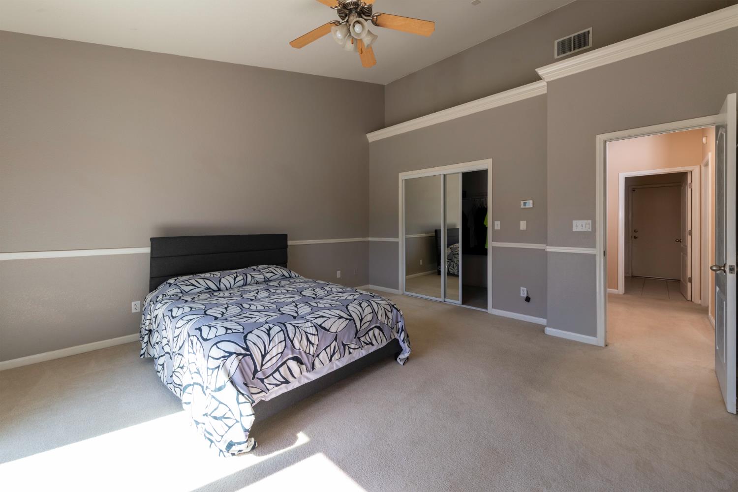6525 East Raco Avenue Fresno, CA 93727 - Photo 17 of 27 a bedroom with a bed and a ceiling fan