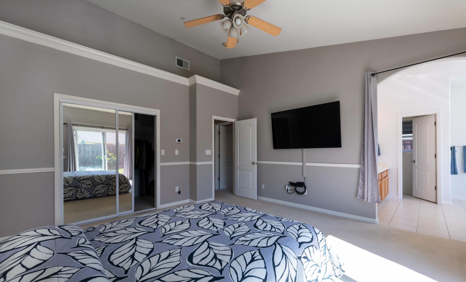 6525 East Raco Avenue Fresno, CA 93727 - Photo 18 of 27 a bedroom with a bed and a flat screen tv