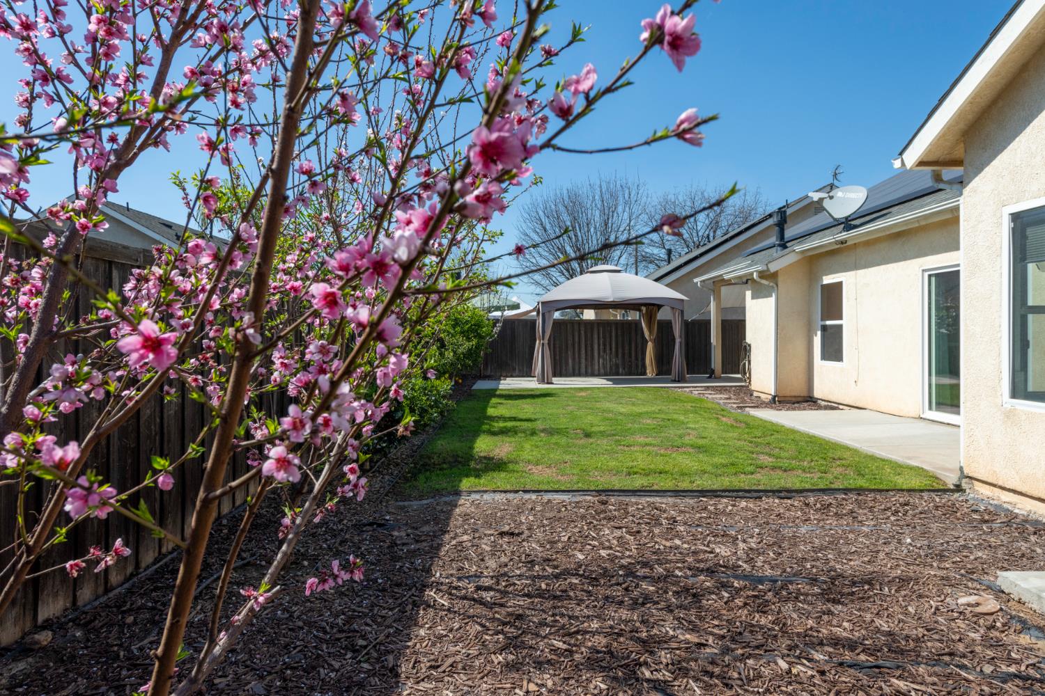 6525 East Raco Avenue Fresno, CA 93727 - Photo 22 of 27 a front view of a house with a yard