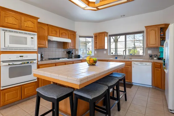 a kitchen with stainless steel appliances granite countertop a sink and cabinets