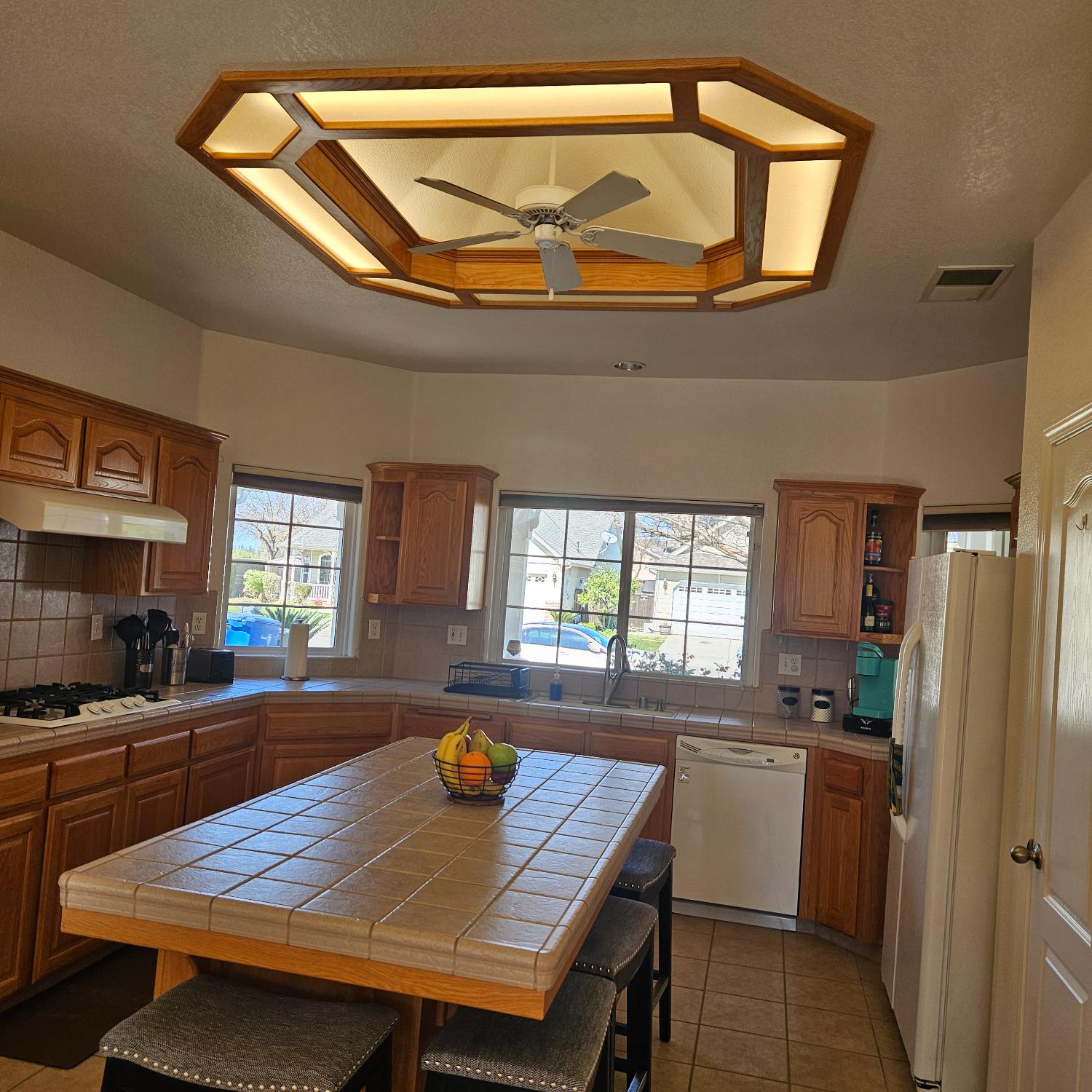 6525 East Raco Avenue Fresno, CA 93727 - Photo 8 of 27 a kitchen with a table chairs and a refrigerator