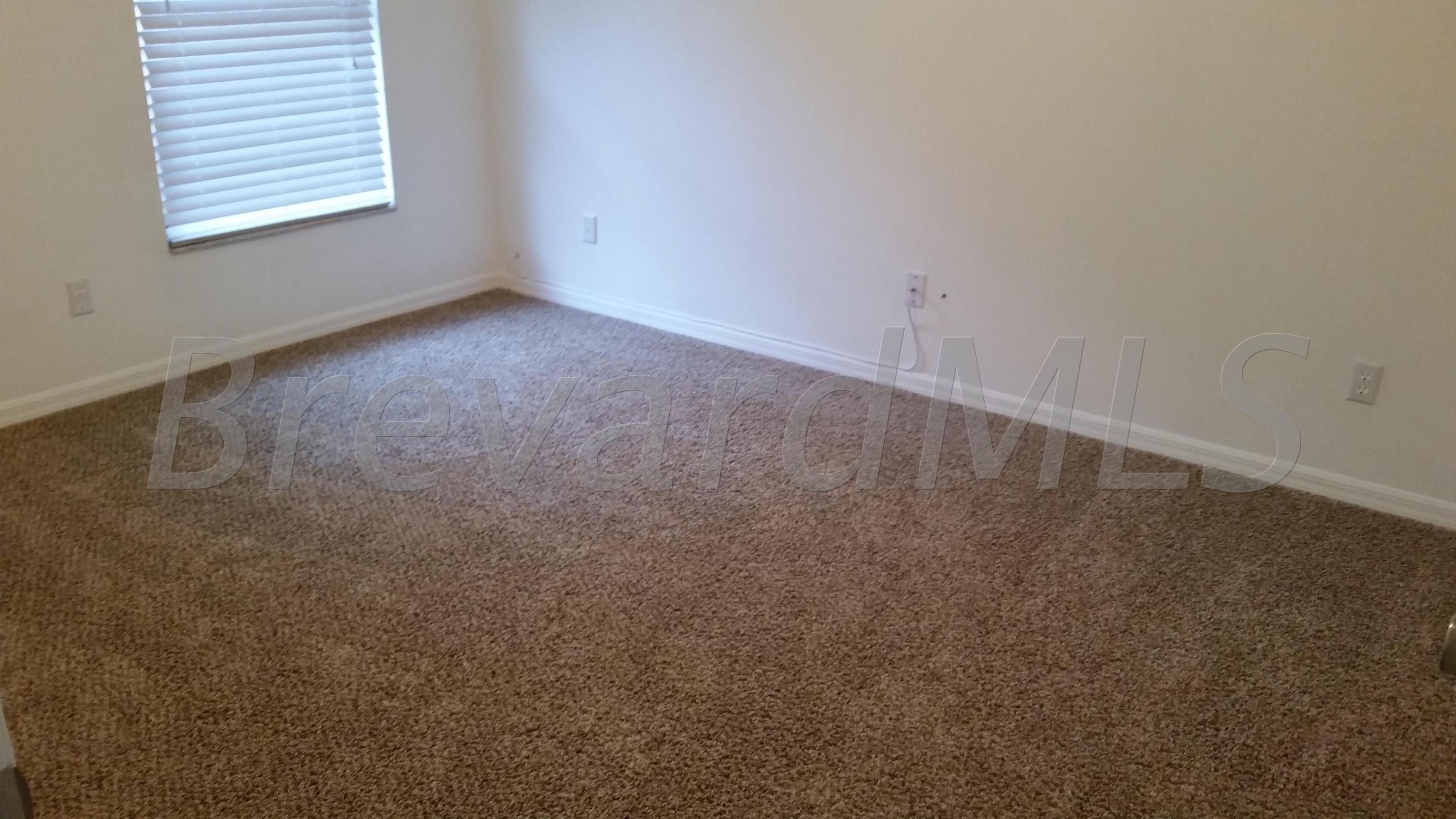 441 Wildmer Road Southwest Palm Bay, FL 32908 - Photo 11 of 67 an empty room with a window
