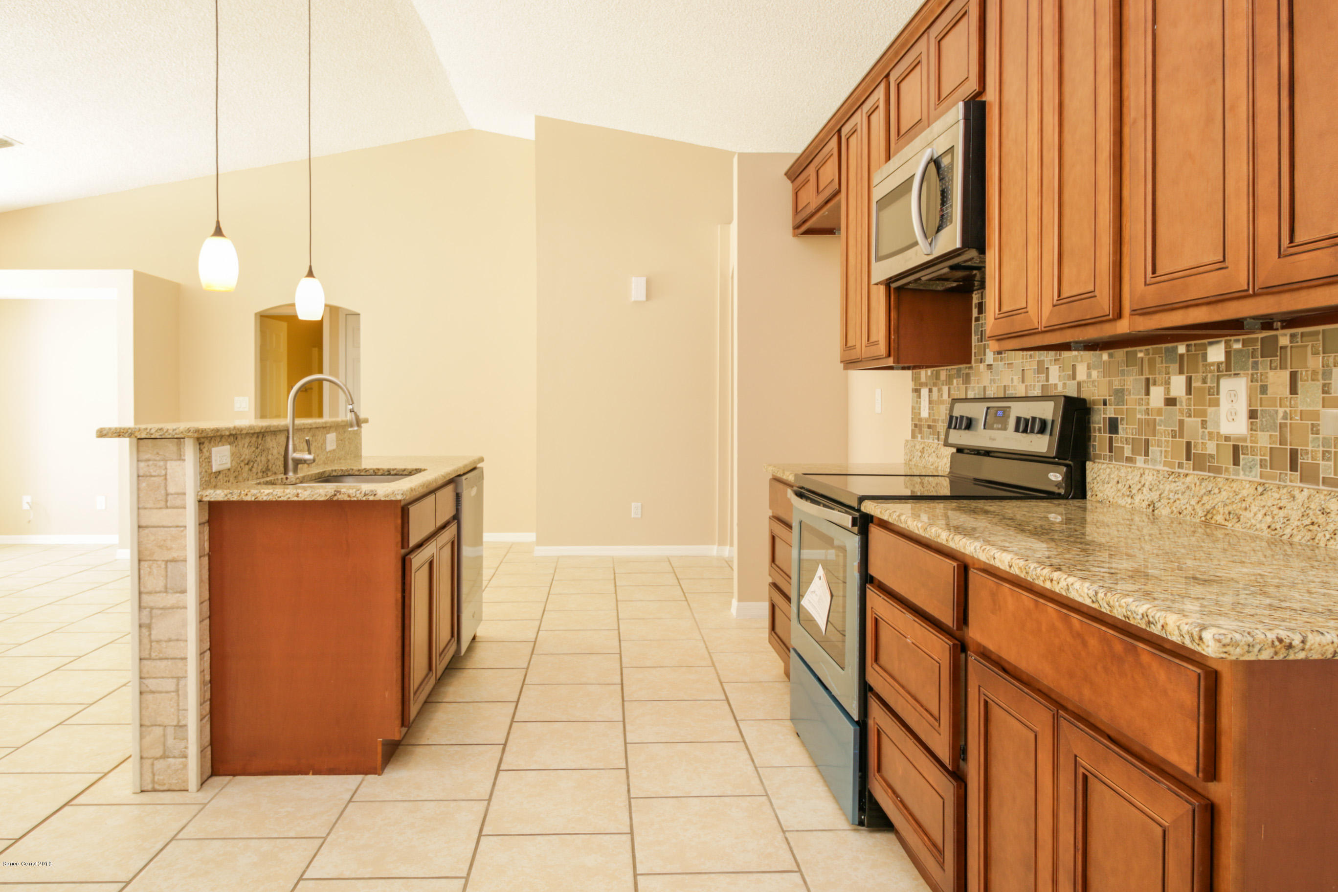 441 Wildmer Road Southwest Palm Bay, FL 32908 - Photo 22 of 67 a kitchen with stainless steel appliances granite countertop a sink and cabinets