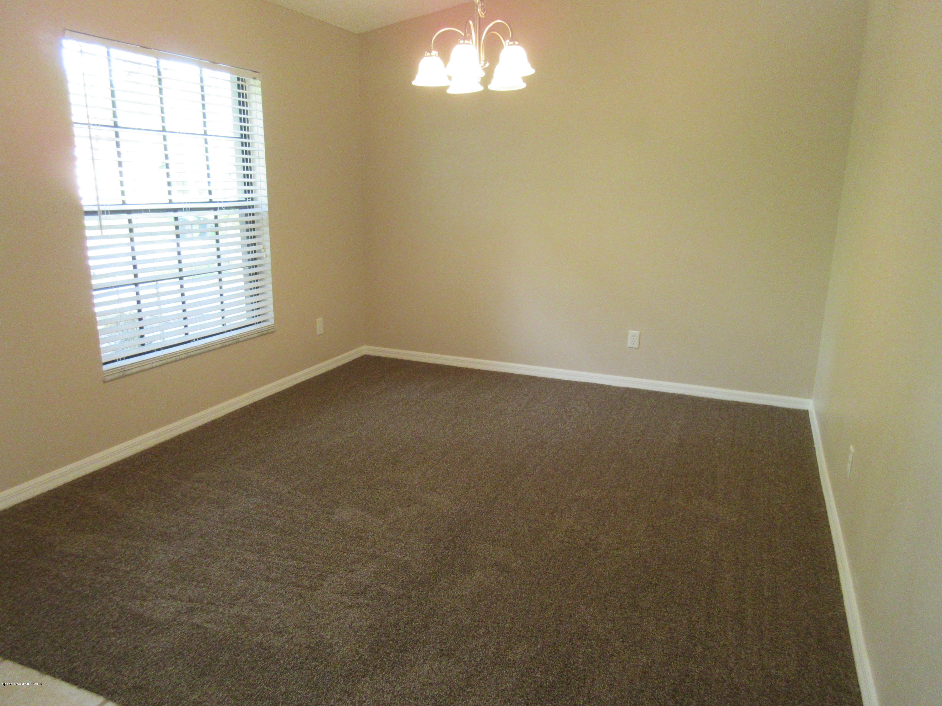 441 Wildmer Road Southwest Palm Bay, FL 32908 - Photo 23 of 67 an empty room with a empty space and windows