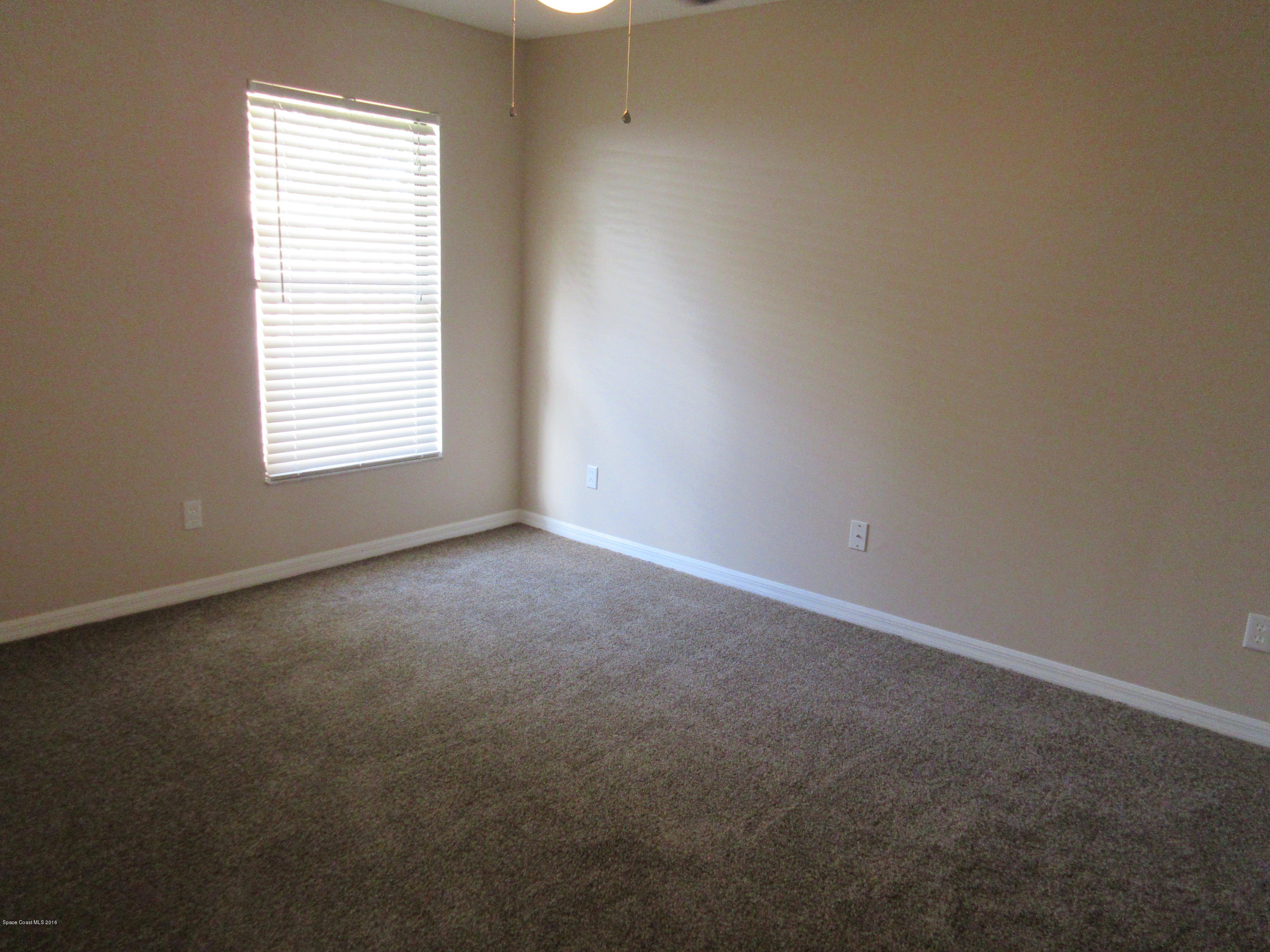 441 Wildmer Road Southwest Palm Bay, FL 32908 - Photo 25 of 67 an empty room with a window