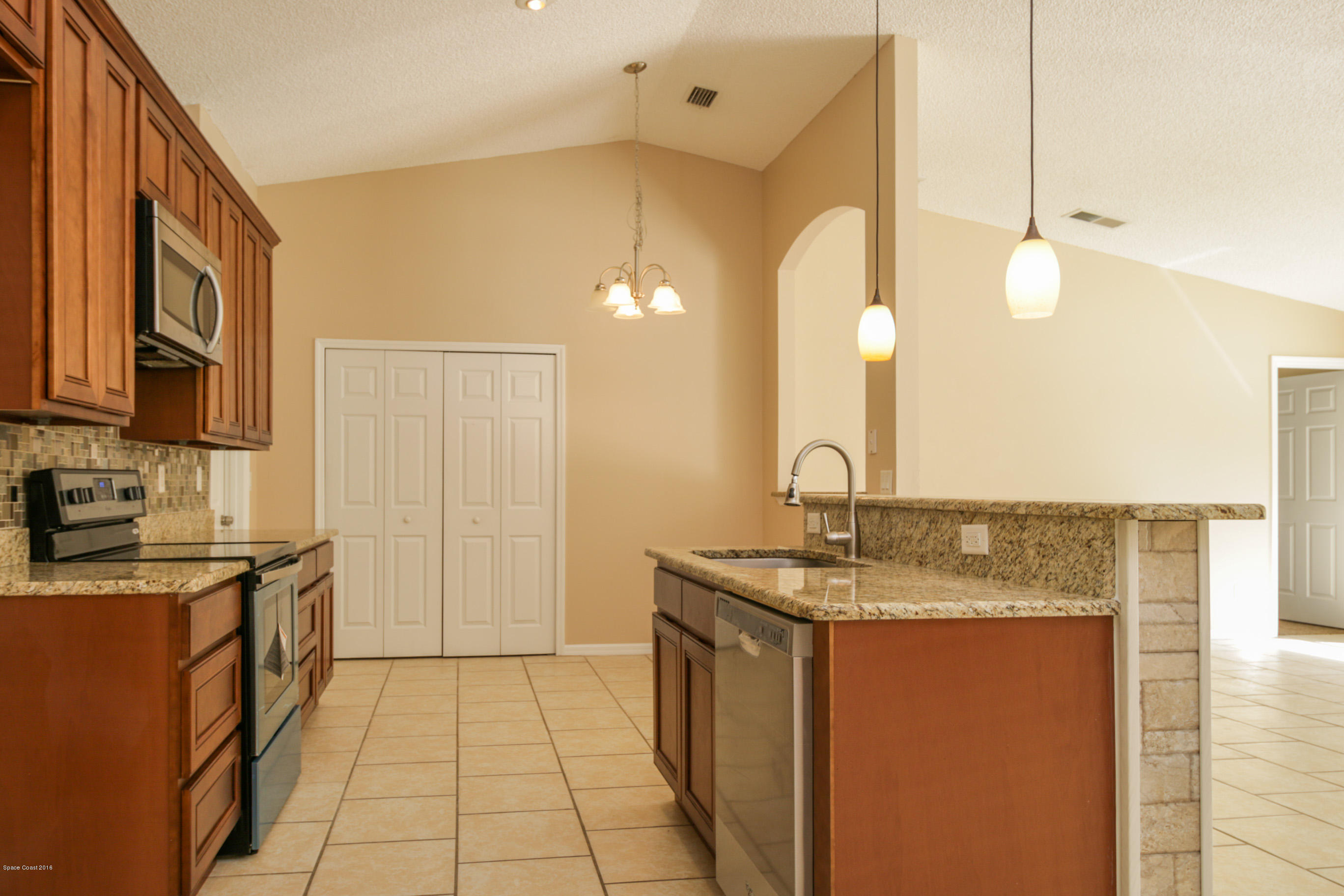 441 Wildmer Road Southwest Palm Bay, FL 32908 - Photo 27 of 67 a bathroom with a granite countertop sink a mirror and a shower