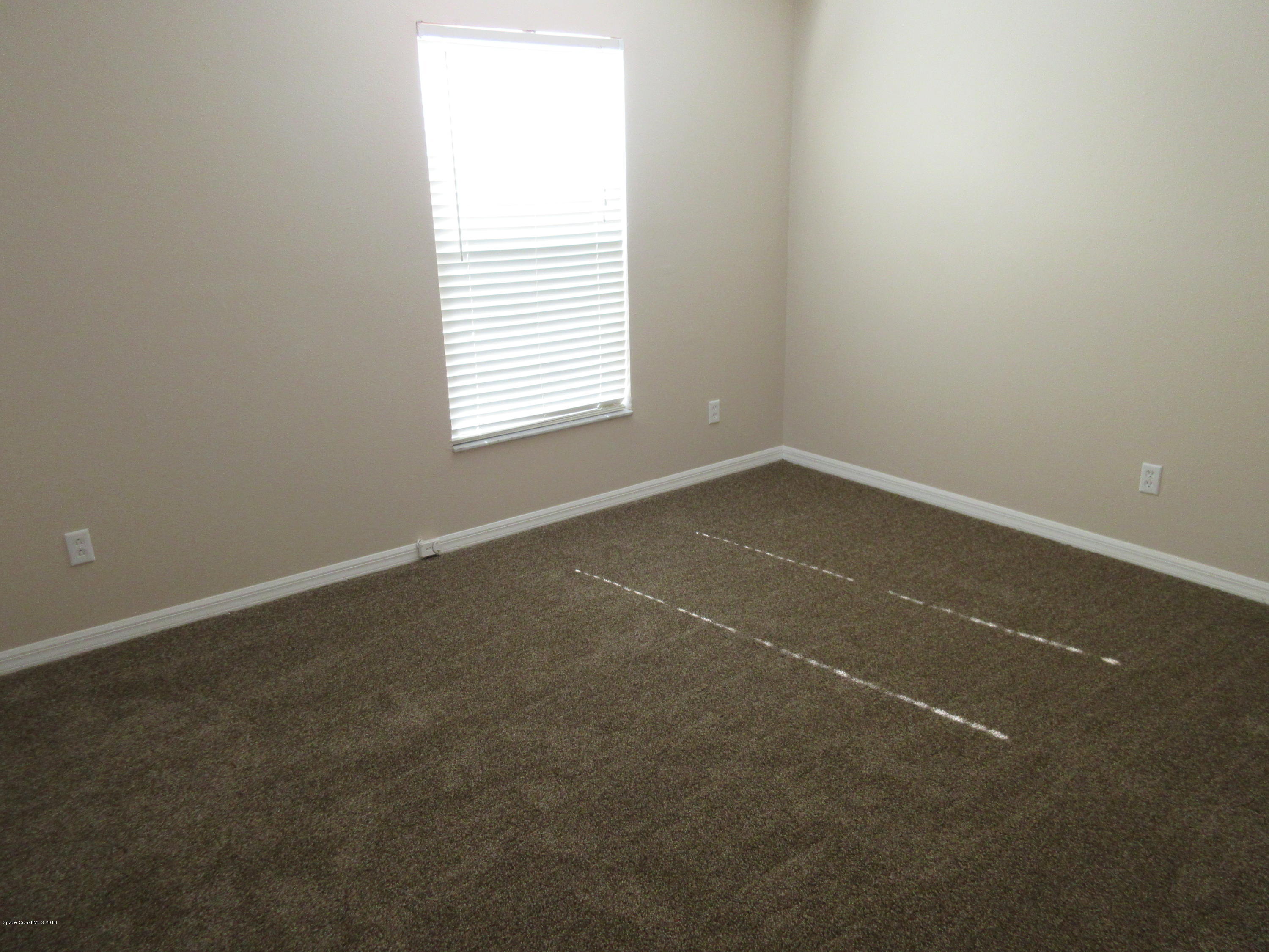 441 Wildmer Road Southwest Palm Bay, FL 32908 - Photo 28 of 67 an empty room with a window