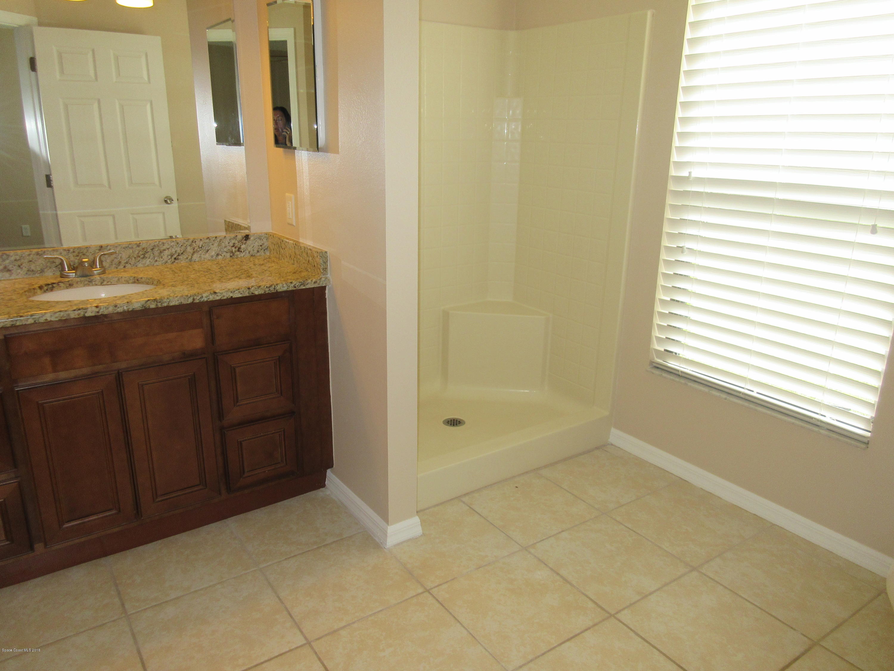 441 Wildmer Road Southwest Palm Bay, FL 32908 - Photo 36 of 67 a bathroom with a granite countertop sink and a mirror