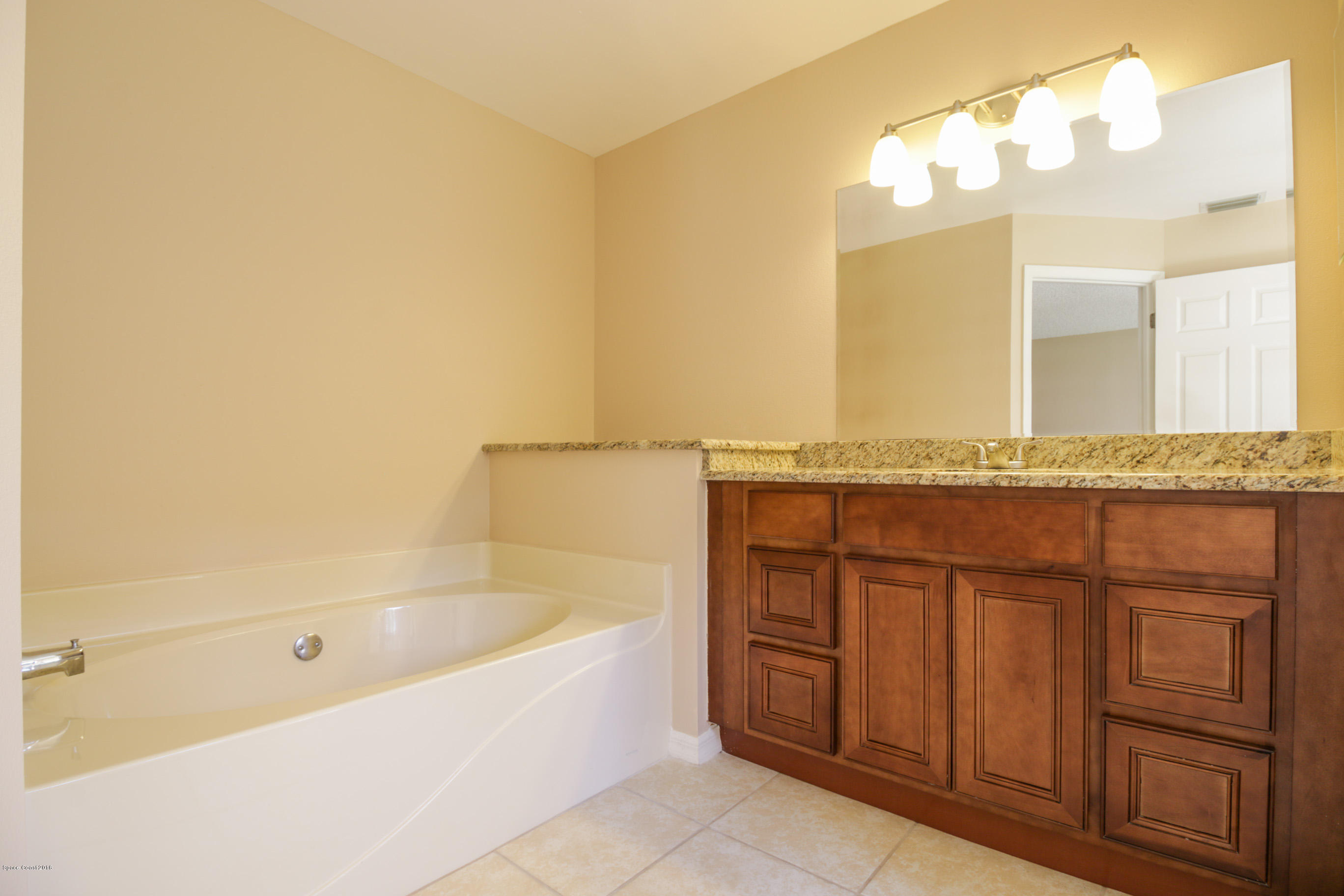 441 Wildmer Road Southwest Palm Bay, FL 32908 - Photo 37 of 67 a bathroom with a bathtub and a sink