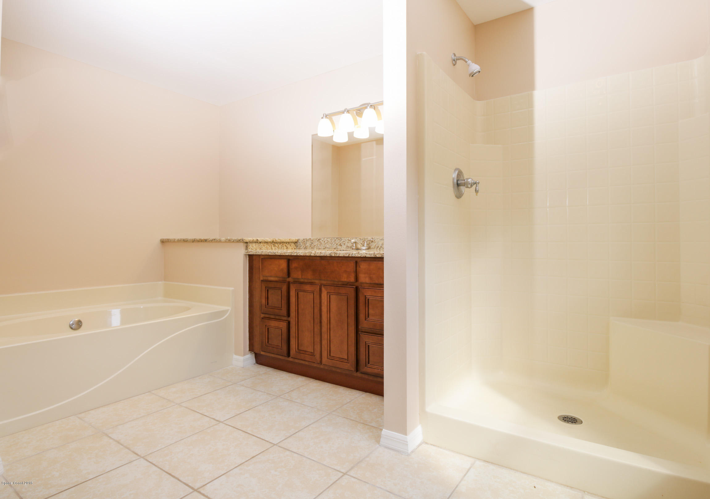 441 Wildmer Road Southwest Palm Bay, FL 32908 - Photo 41 of 67 a bathroom with a bathtub and a shower