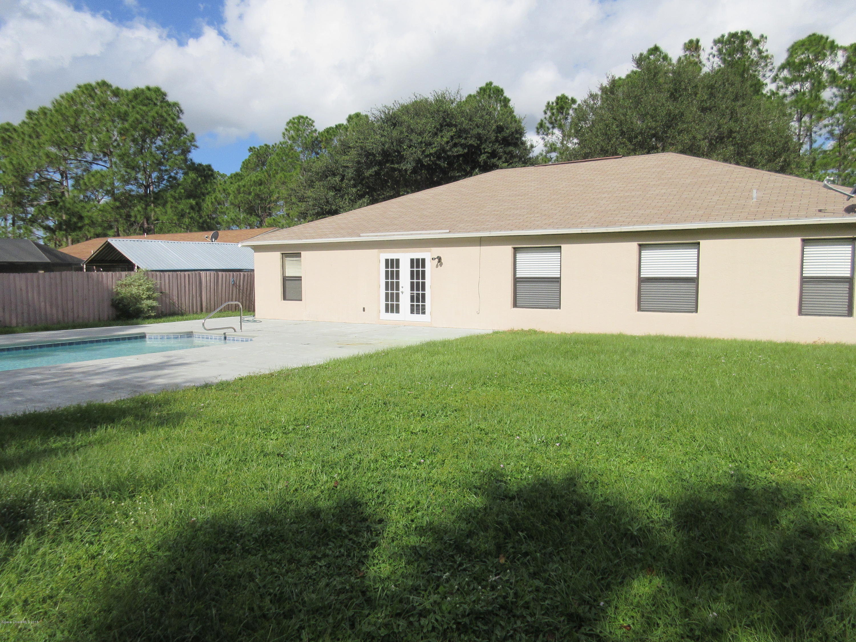 441 Wildmer Road Southwest Palm Bay, FL 32908 - Photo 44 of 67 a view of a house with a yard and fence
