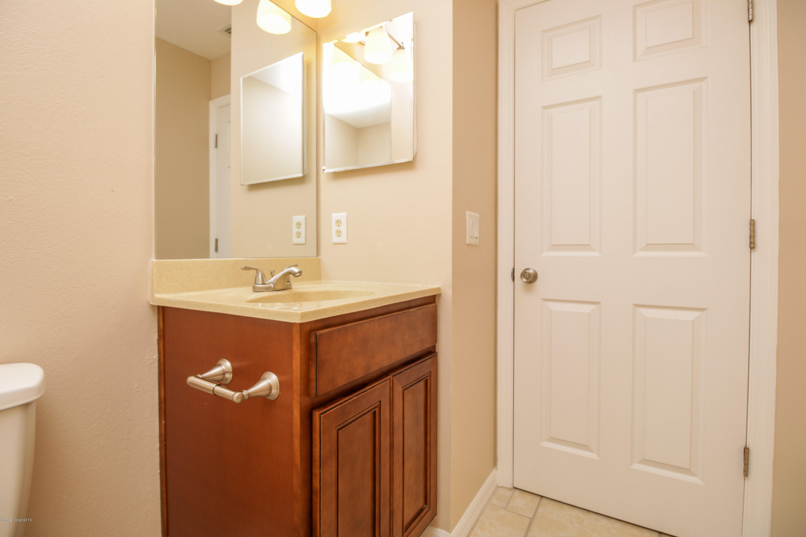 441 Wildmer Road Southwest Palm Bay, FL 32908 - Photo 53 of 67 a bathroom with a sink and a mirror