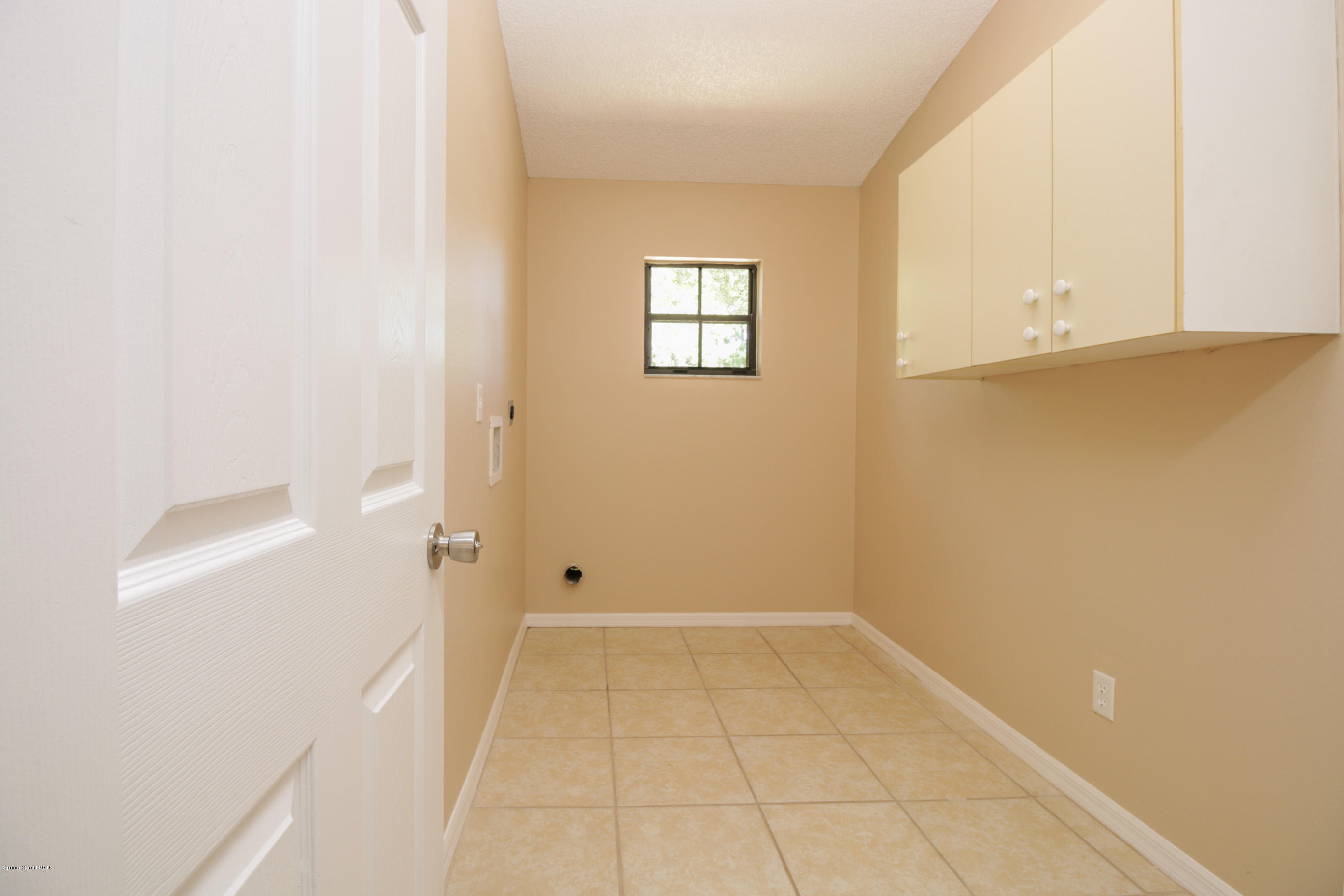 441 Wildmer Road Southwest Palm Bay, FL 32908 - Photo 56 of 67 a view of an empty room with a window