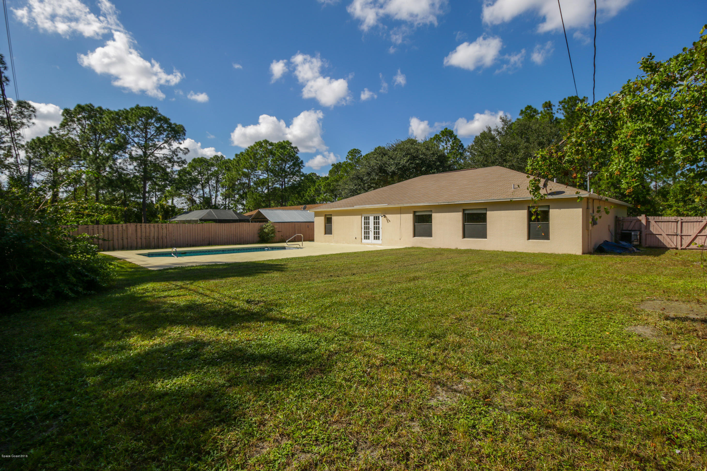 441 Wildmer Road Southwest Palm Bay, FL 32908 - Photo 59 of 67 a front view of a house with a yard