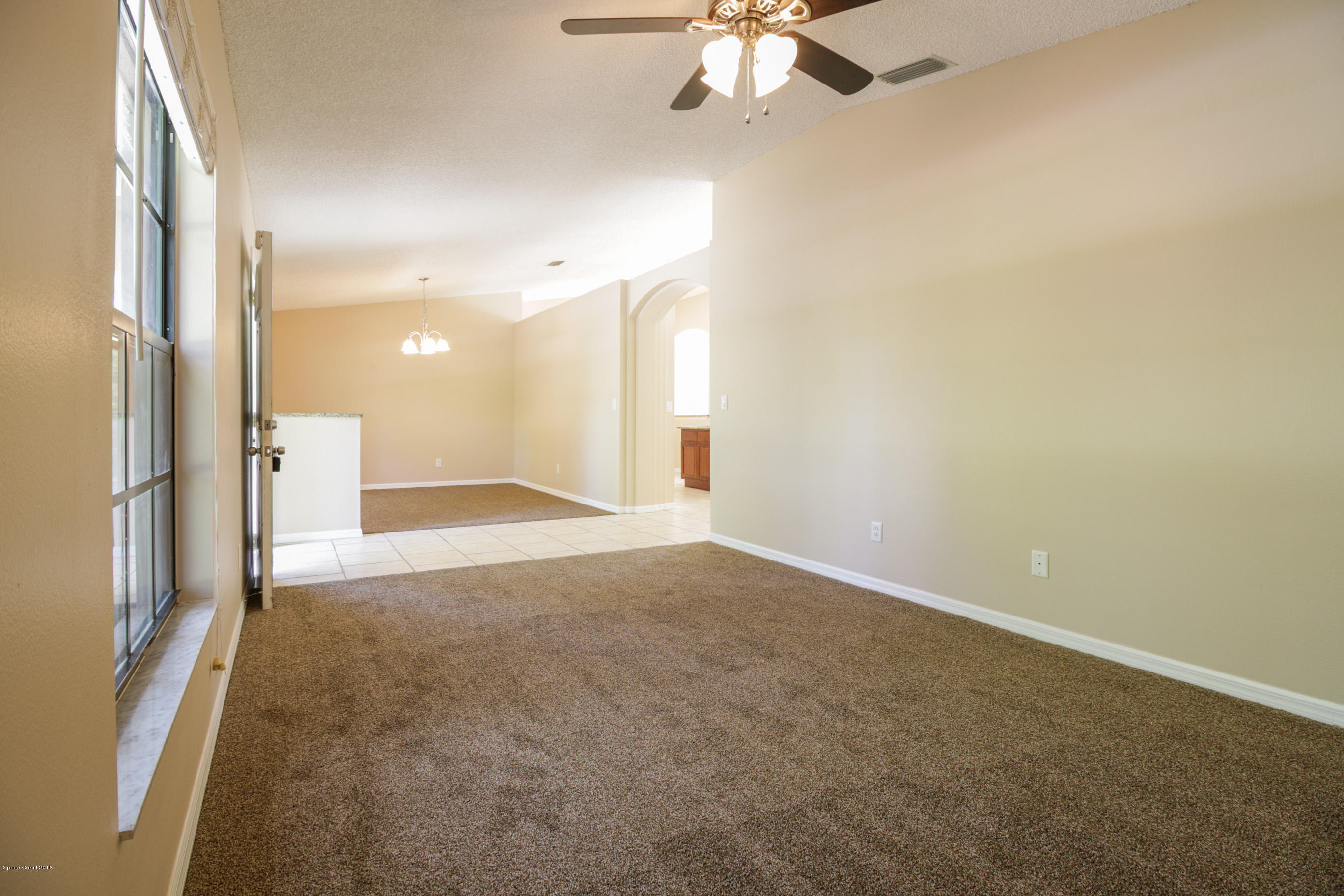441 Wildmer Road Southwest Palm Bay, FL 32908 - Photo 7 of 67 a view of a livingroom with a ceiling fan and window