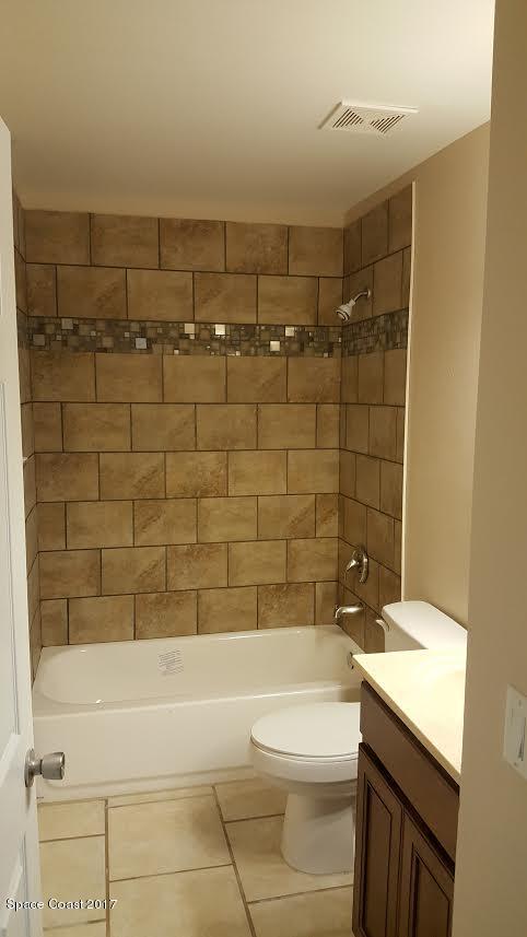 441 Wildmer Road Southwest Palm Bay, FL 32908 - Photo 66 of 67 a bathroom with a bathtub a sink a toilet and a shower
