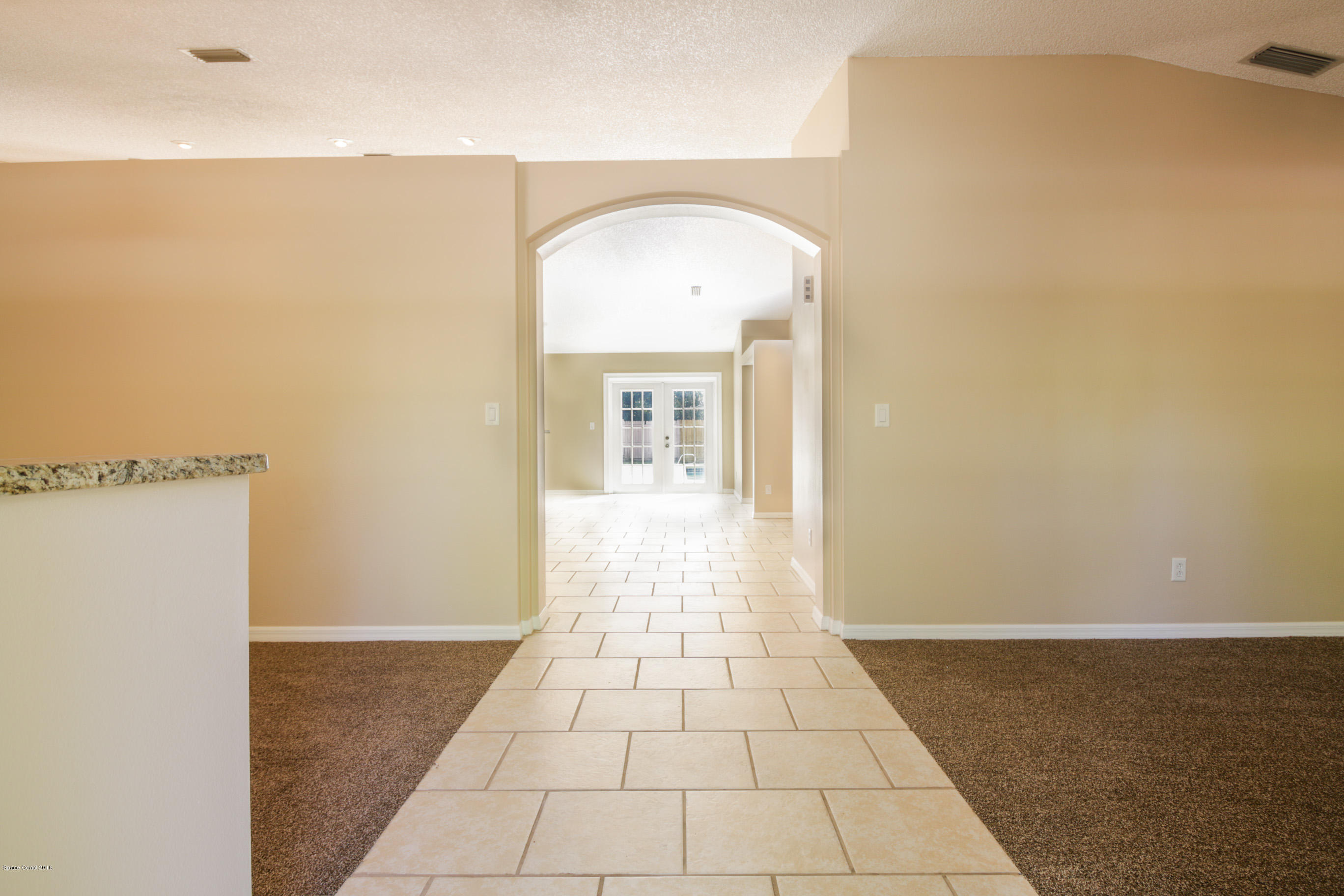 441 Wildmer Road Southwest Palm Bay, FL 32908 - Photo 8 of 67 a view of a hallway with wooden floor and a living room