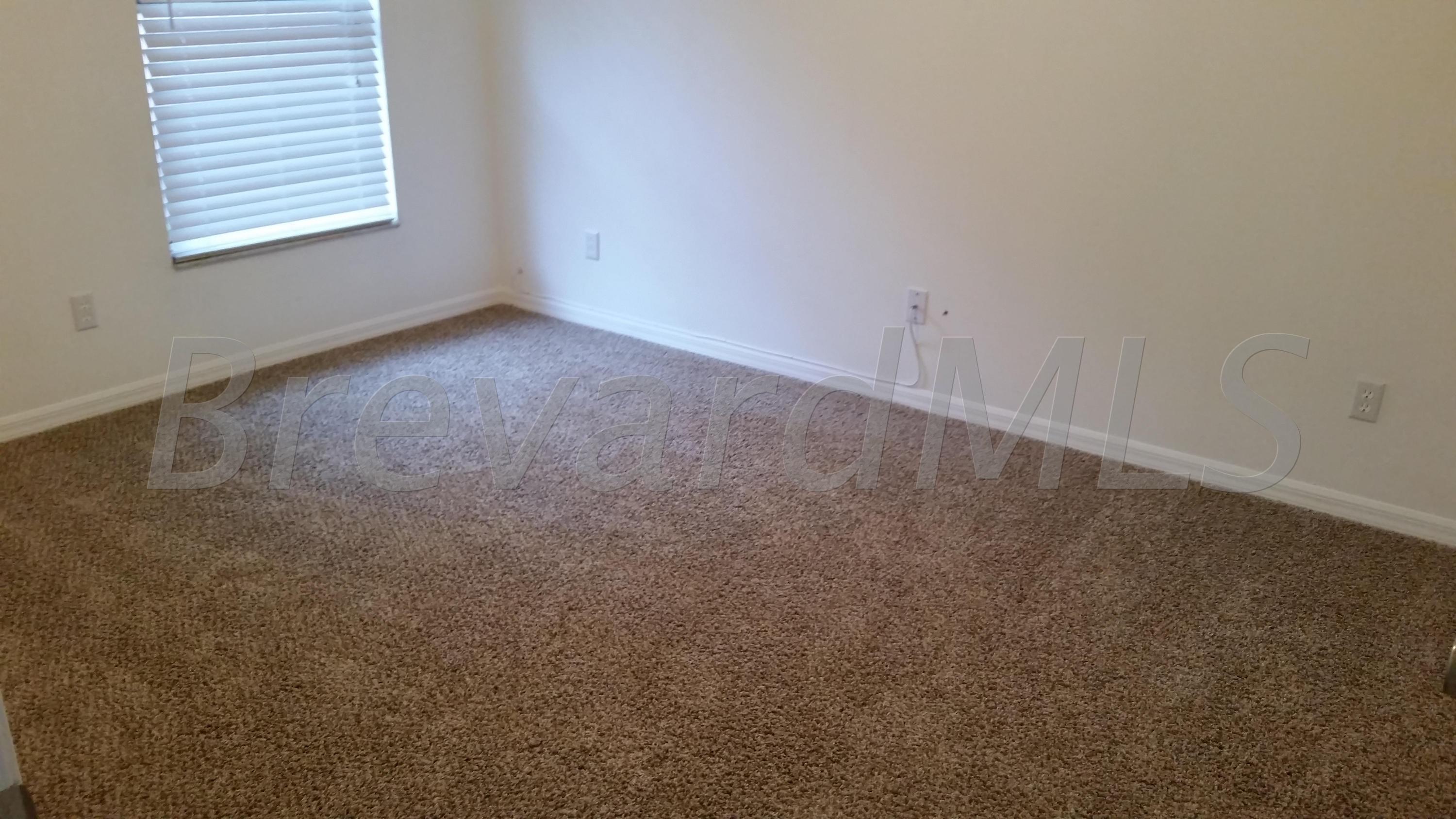 441 Wildmer Road Southwest Palm Bay, FL 32908 - Photo 9 of 67 an empty room with a window