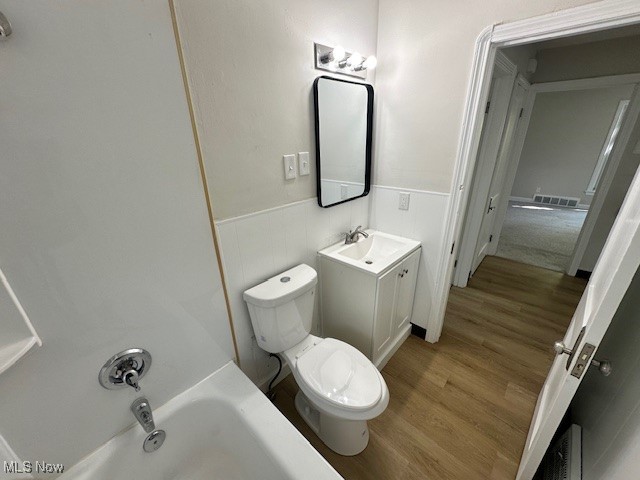 26203 Tryon Road Bedford, OH 44146 - Photo 11 of 18 Bathroom with a tub, toilet, hardwood / wood-style floors, and vanity