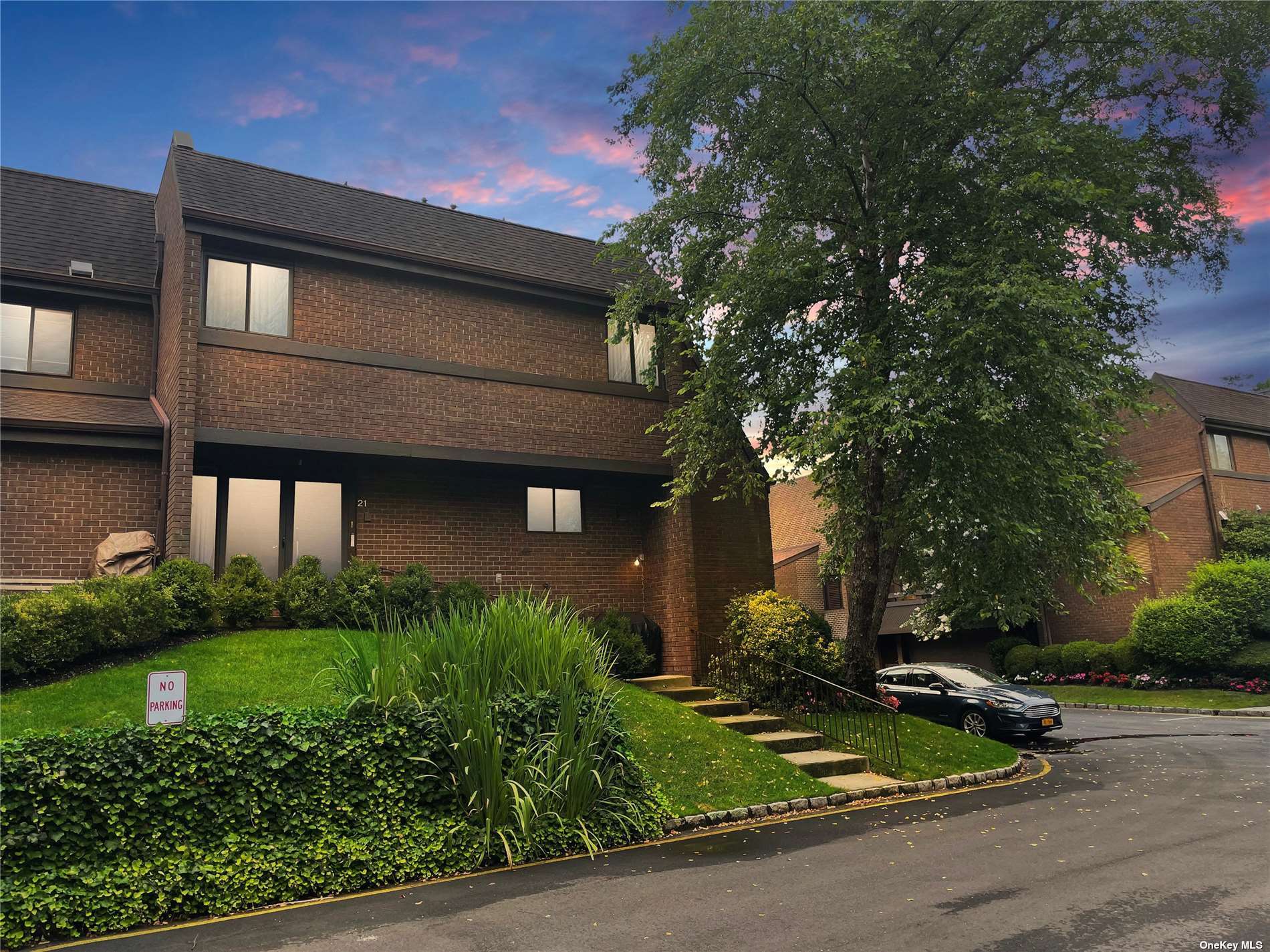 21 Spring Hollow Road, Unit SH21 Roslyn, NY 11576 - Photo 1 of 1 a front view of a house with garden