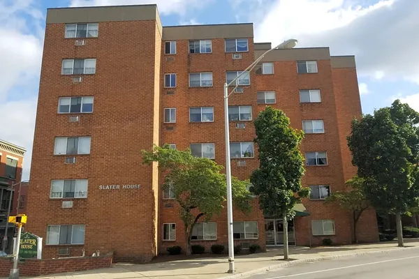 a front view of a building with a yard