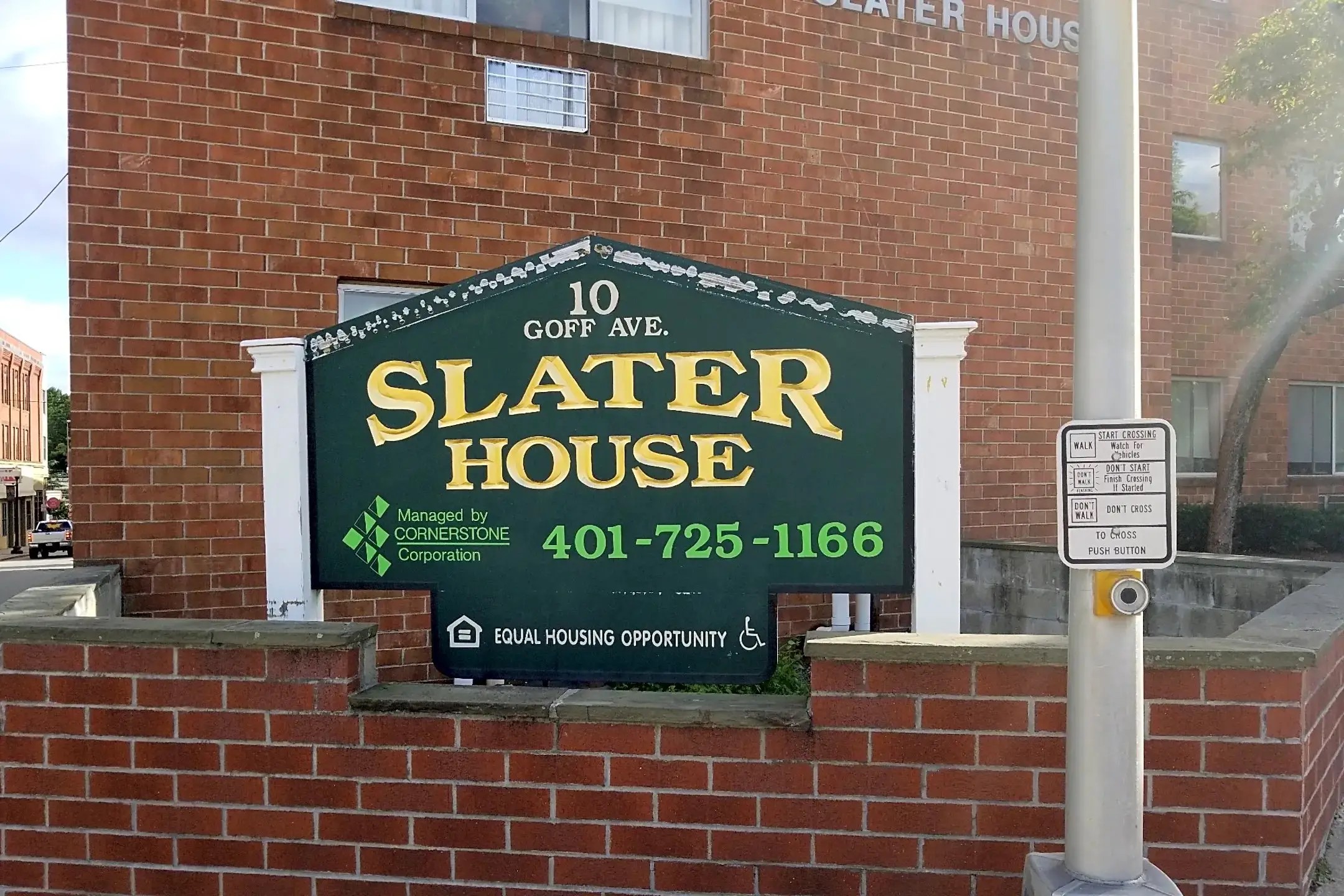 10 Goff Avenue Pawtucket, RI 02860 - Photo 3 of 6 a sign broad on the brick wall