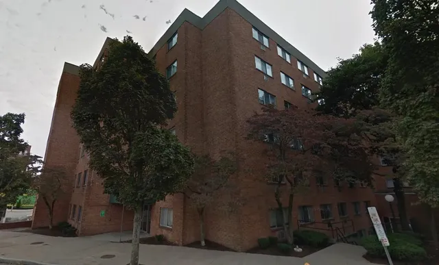 a front view of a building with a yard