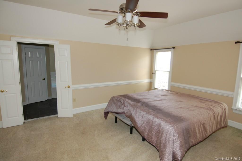 425 St Michaels Way Fort Mill, SC 29708 - Photo 12 of 21 a bedroom with a bed and a ceiling fan