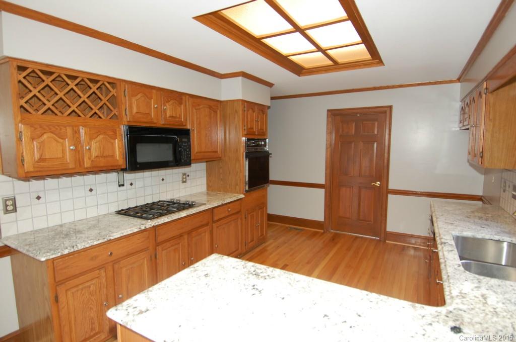 425 St Michaels Way Fort Mill, SC 29708 - Photo 4 of 21 a kitchen with stainless steel appliances kitchen island granite countertop a sink and a microwave
