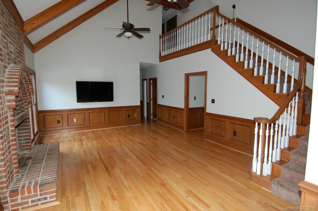 425 St Michaels Way Fort Mill, SC 29708 - Photo 7 of 21 a view of a livingroom with wooden floor and a staircase
