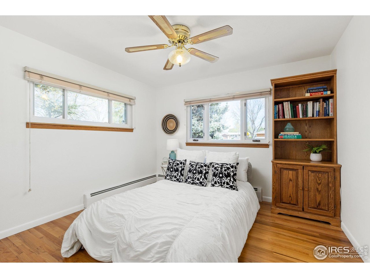 27 Cornell Drive Longmont, CO 80503 - Photo 16 of 33 a bedroom with a bed and a book shelf