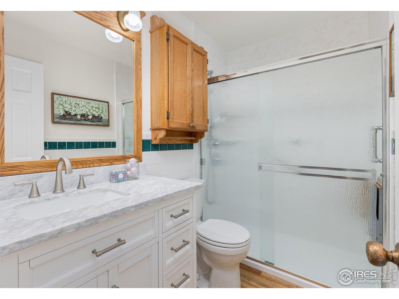 27 Cornell Drive Longmont, CO 80503 - Photo 17 of 33 a bathroom with a sink a toilet and a shower