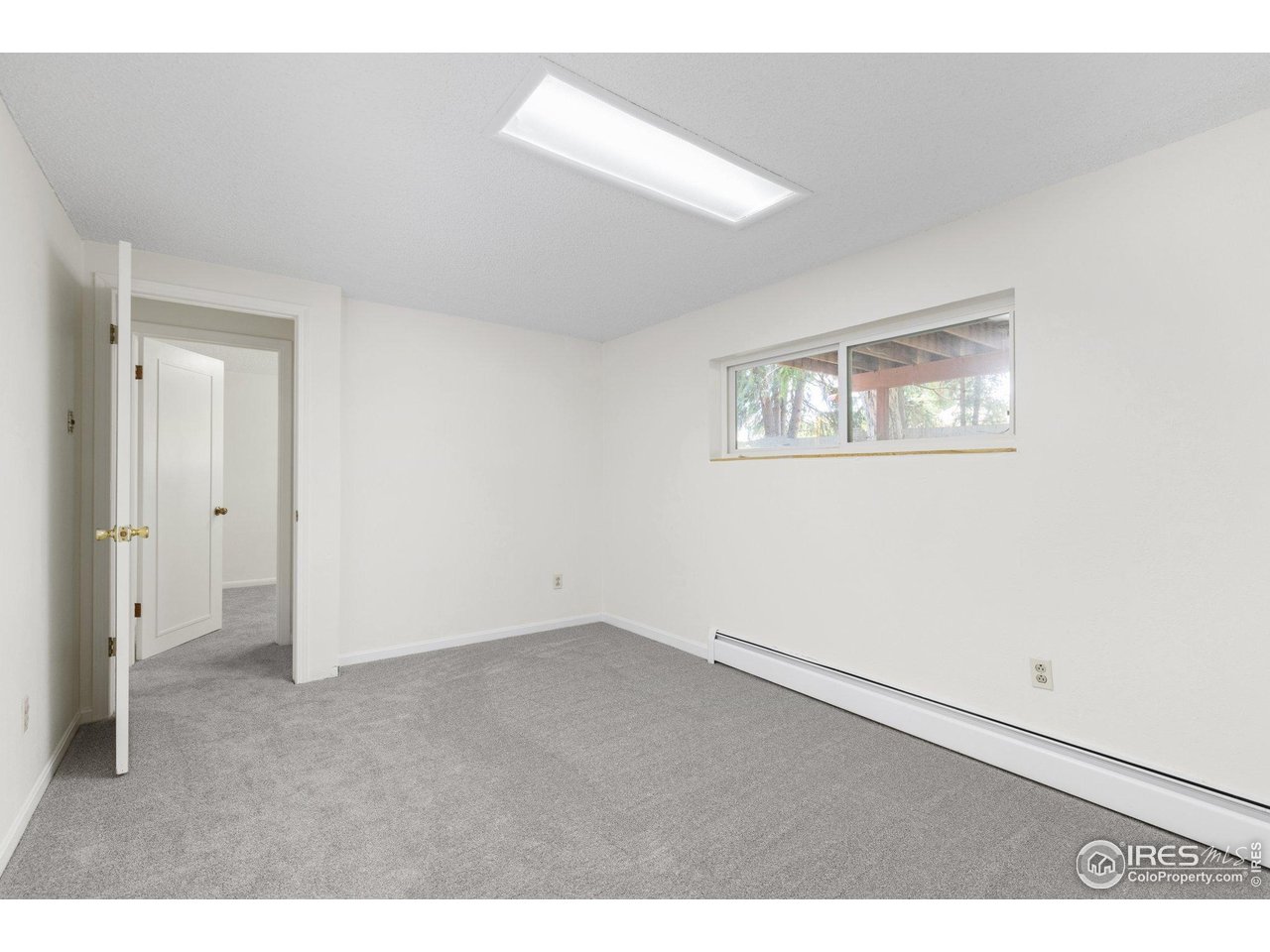 27 Cornell Drive Longmont, CO 80503 - Photo 21 of 33 a view of an empty room with a window