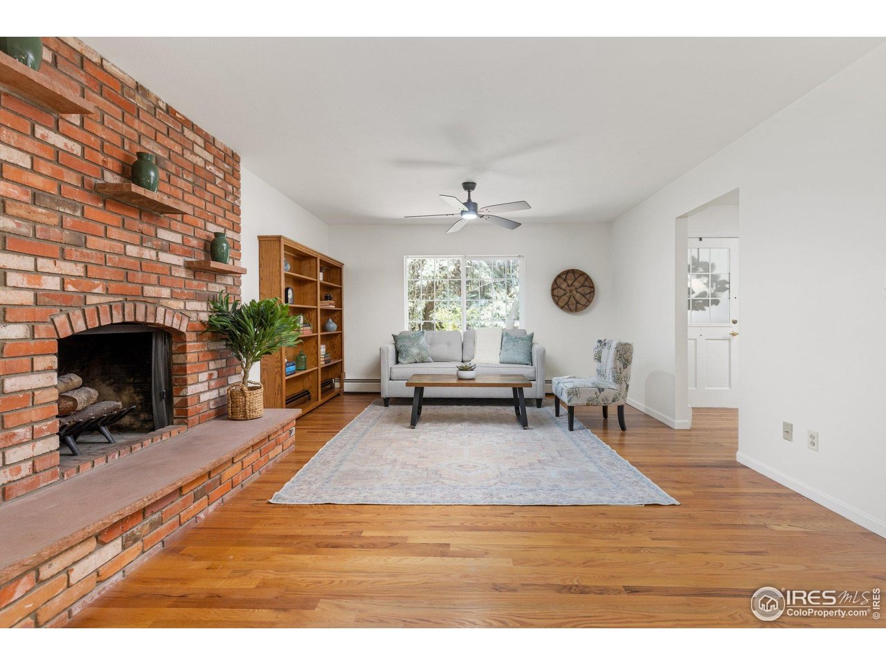 27 Cornell Drive Longmont, CO 80503 - Photo 7 of 33 a living room with furniture and a fireplace