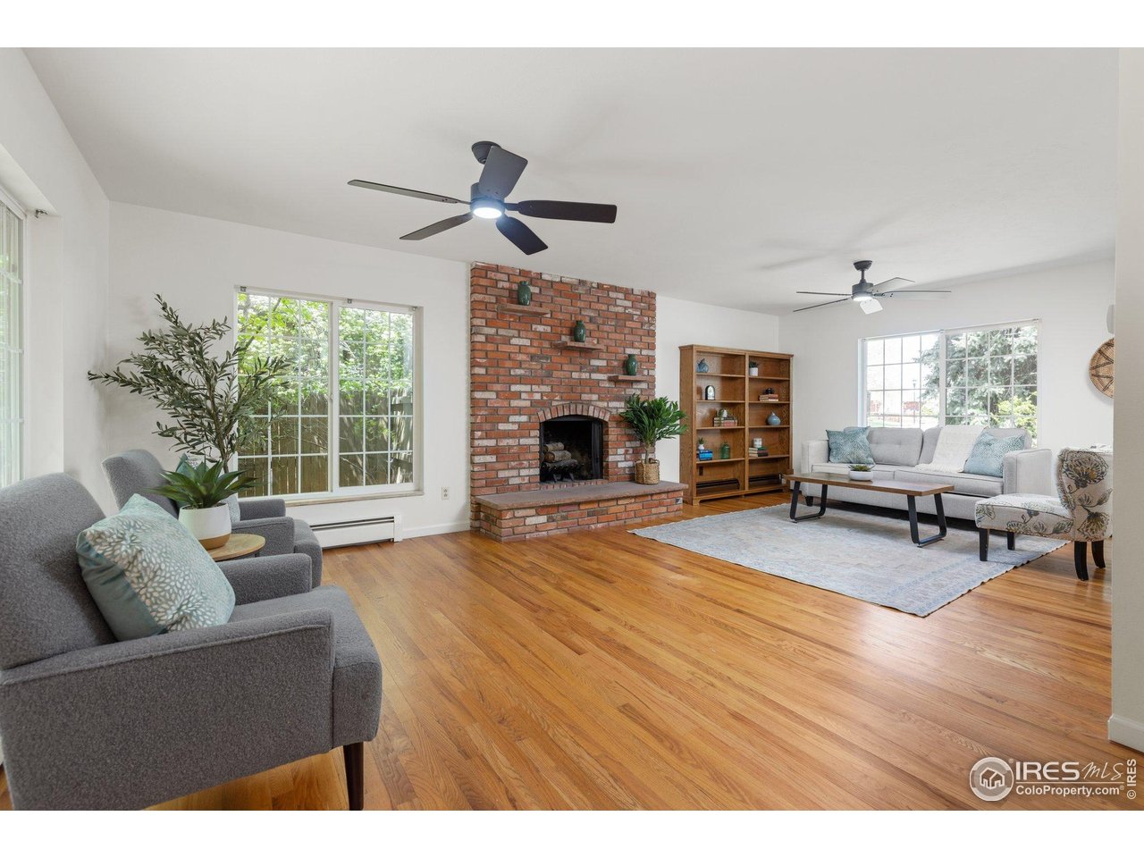 27 Cornell Drive Longmont, CO 80503 - Photo 8 of 33 a living room with furniture and a fireplace