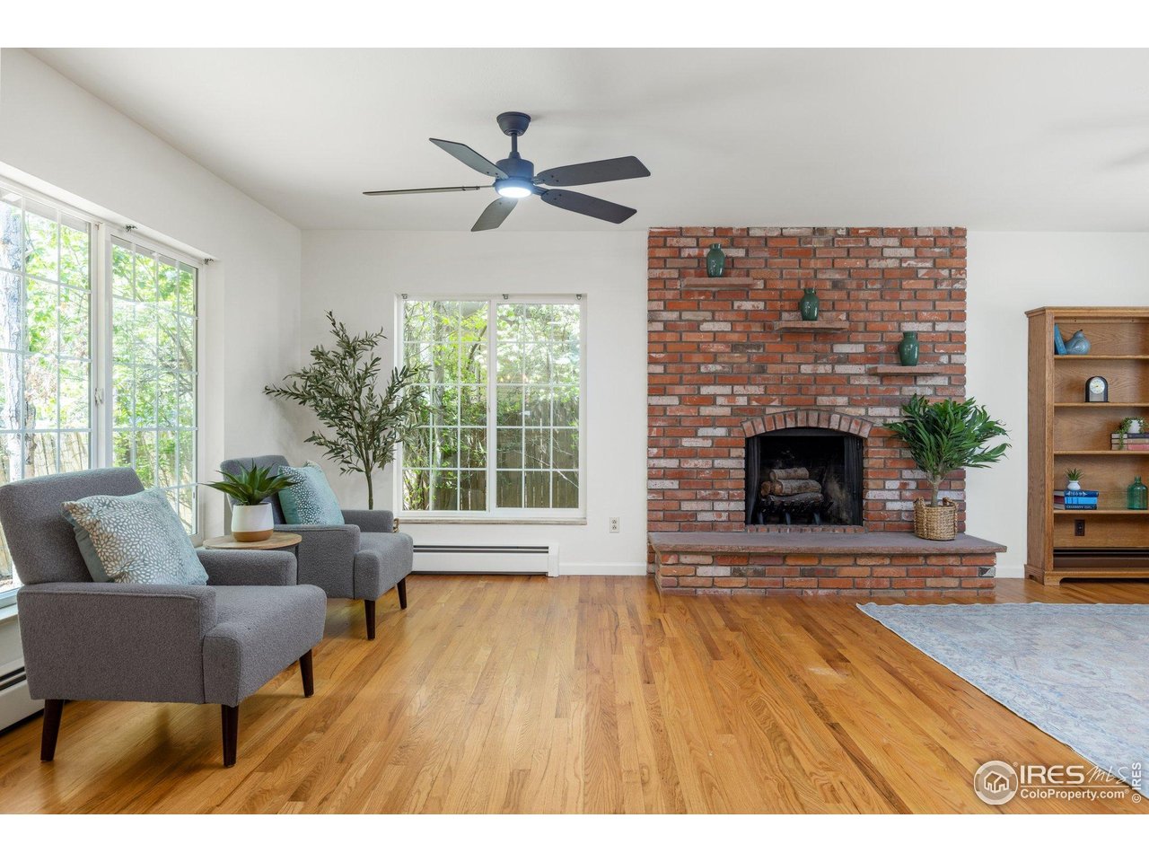 27 Cornell Drive Longmont, CO 80503 - Photo 9 of 33 a living room with furniture and a fireplace