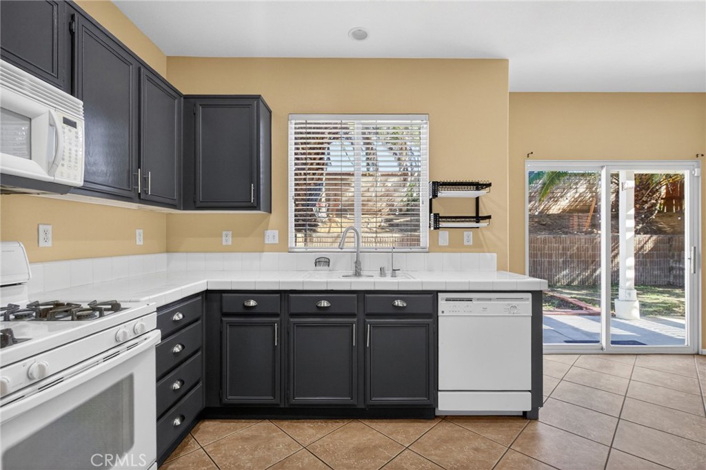3958 Barbury Palms Way Perris, CA 92571 - Photo 4 of 35 a kitchen with a sink and cabinets