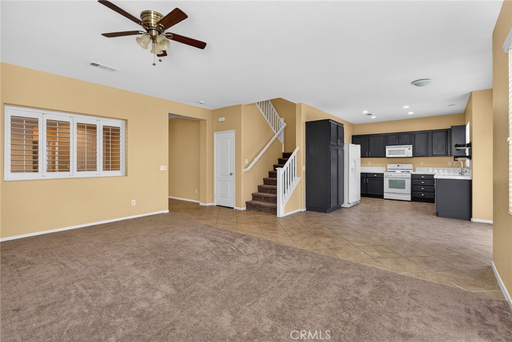 3958 Barbury Palms Way Perris, CA 92571 - Photo 7 of 35 a view of a livingroom with a ceiling fan and window