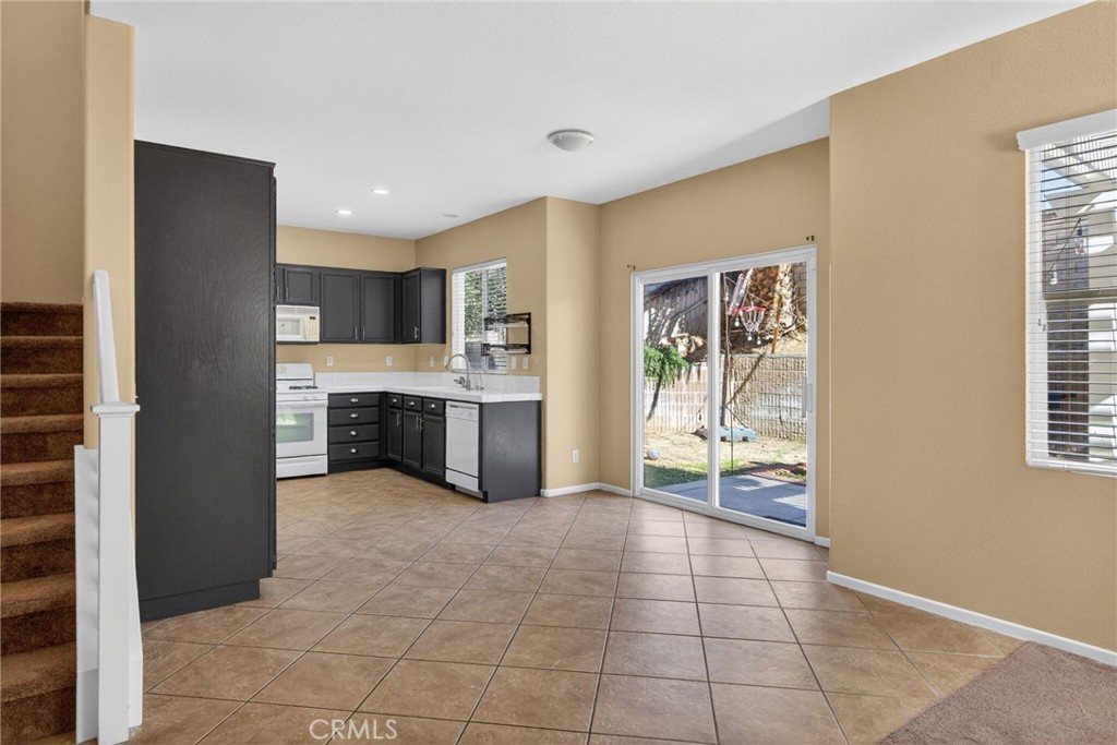 3958 Barbury Palms Way Perris, CA 92571 - Photo 8 of 35 a large kitchen with a stove a refrigerator and a sink