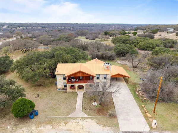 an aerial view of a house with a yard