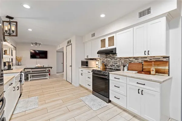 a kitchen with stainless steel appliances granite countertop a stove and a sink